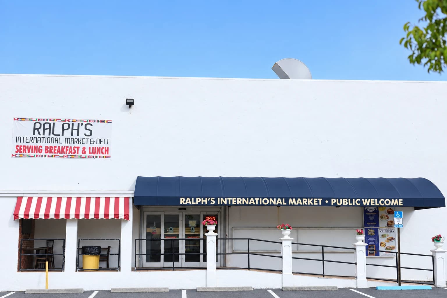 The exterior of Ralph’s International Market, with its navy and red-and-white awnings